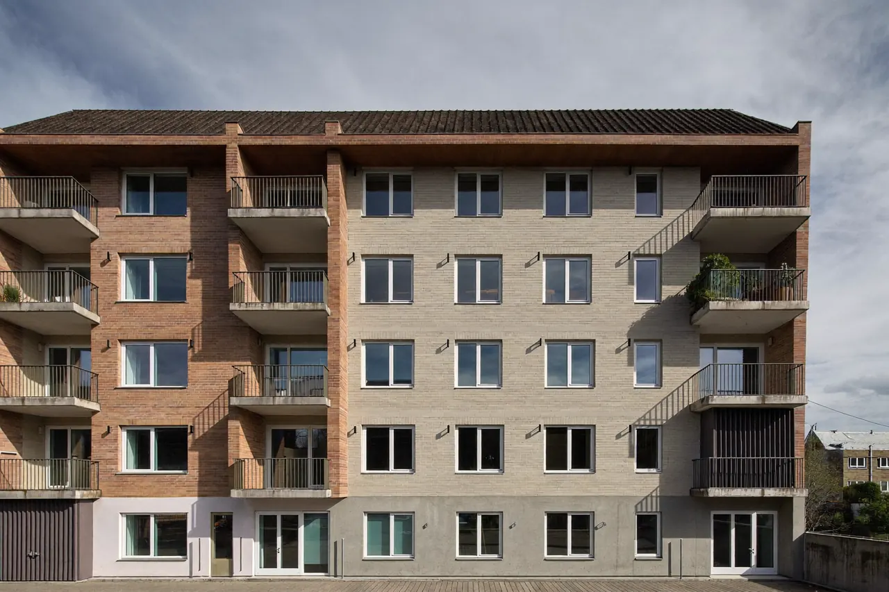 Low-rise apartment block with matching uniform windows across every flat