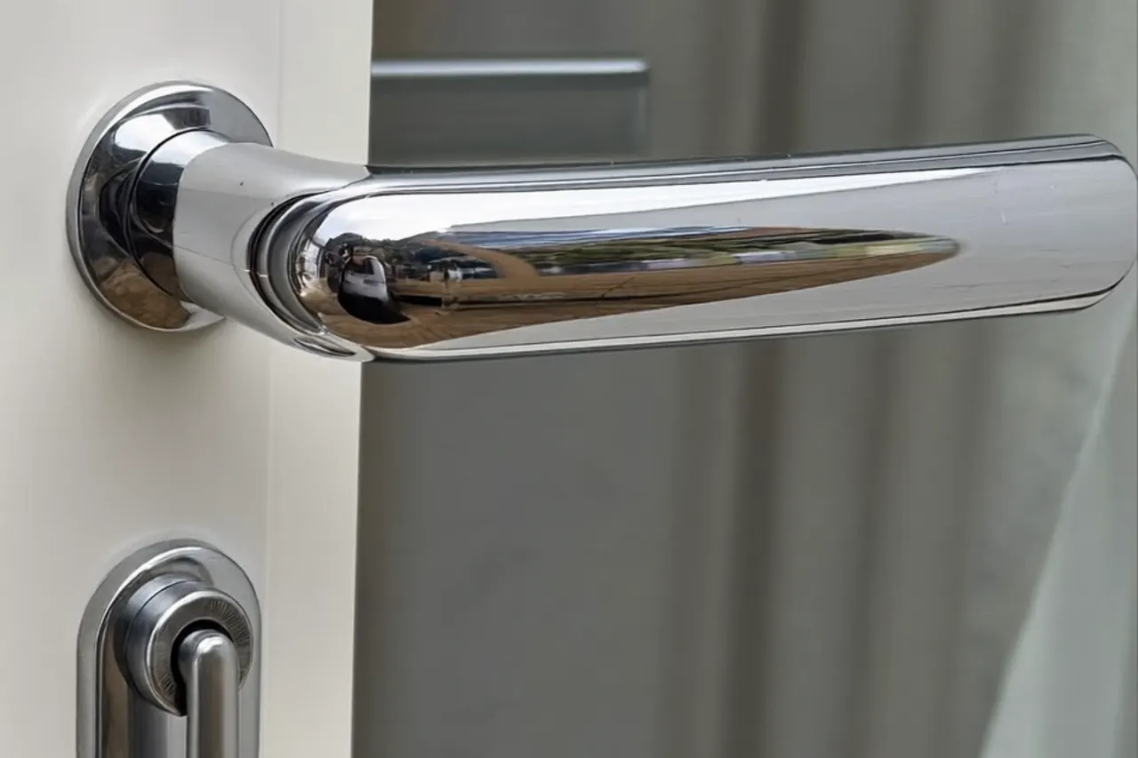 Close-up of a window restrictor and multi-point lock fitted to an upper-floor flat