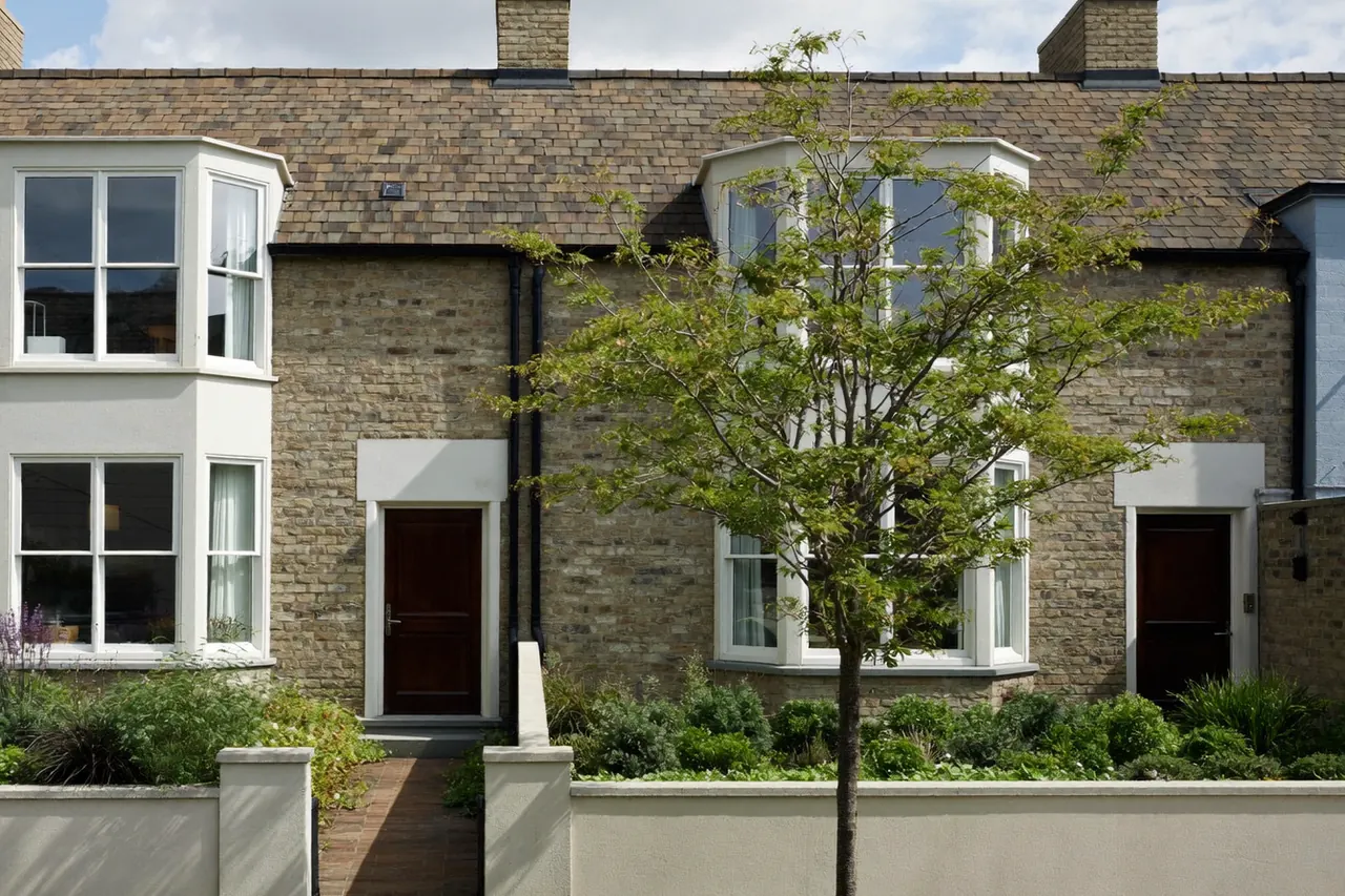 Row of different UK home types — terrace, semi, bungalow and flats — side by side