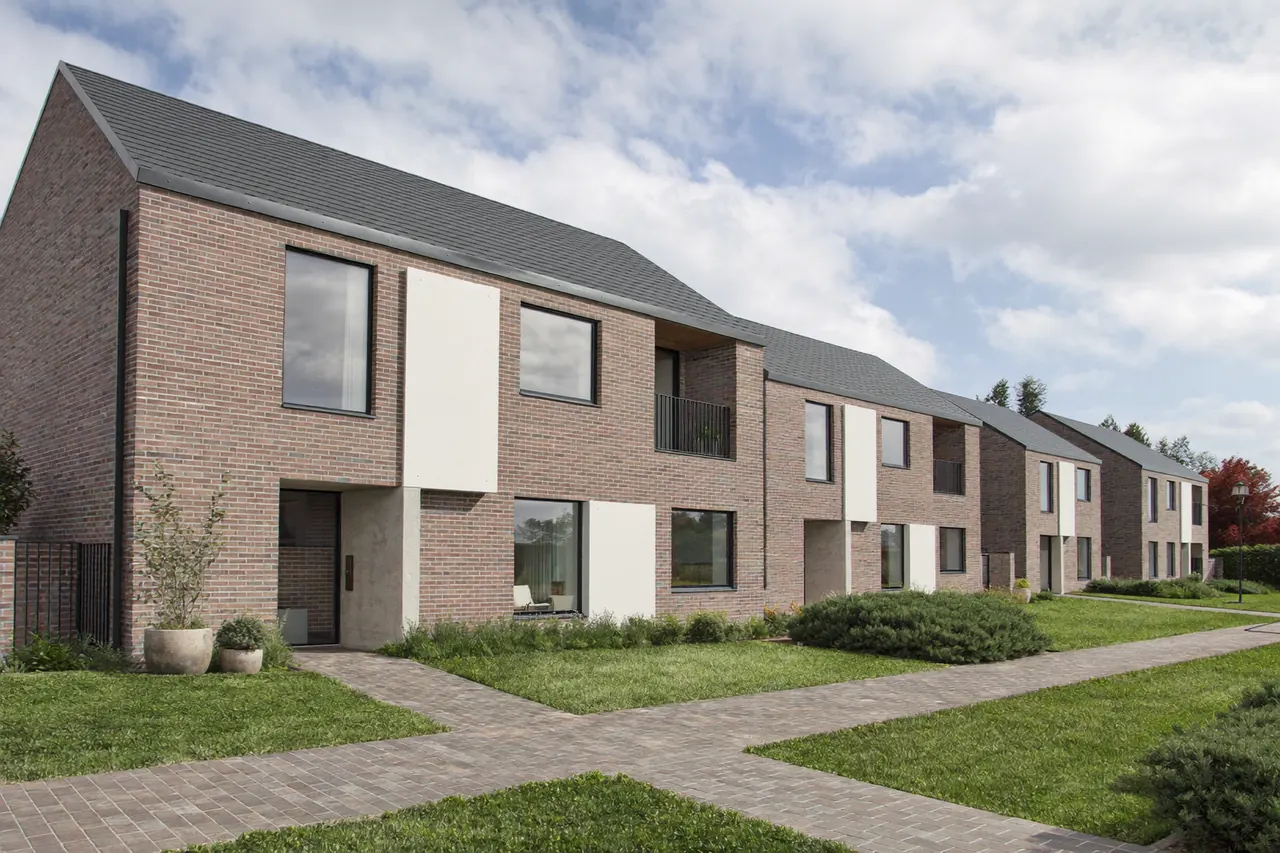 Street of newly built homes with modern casement windows and rendered fronts