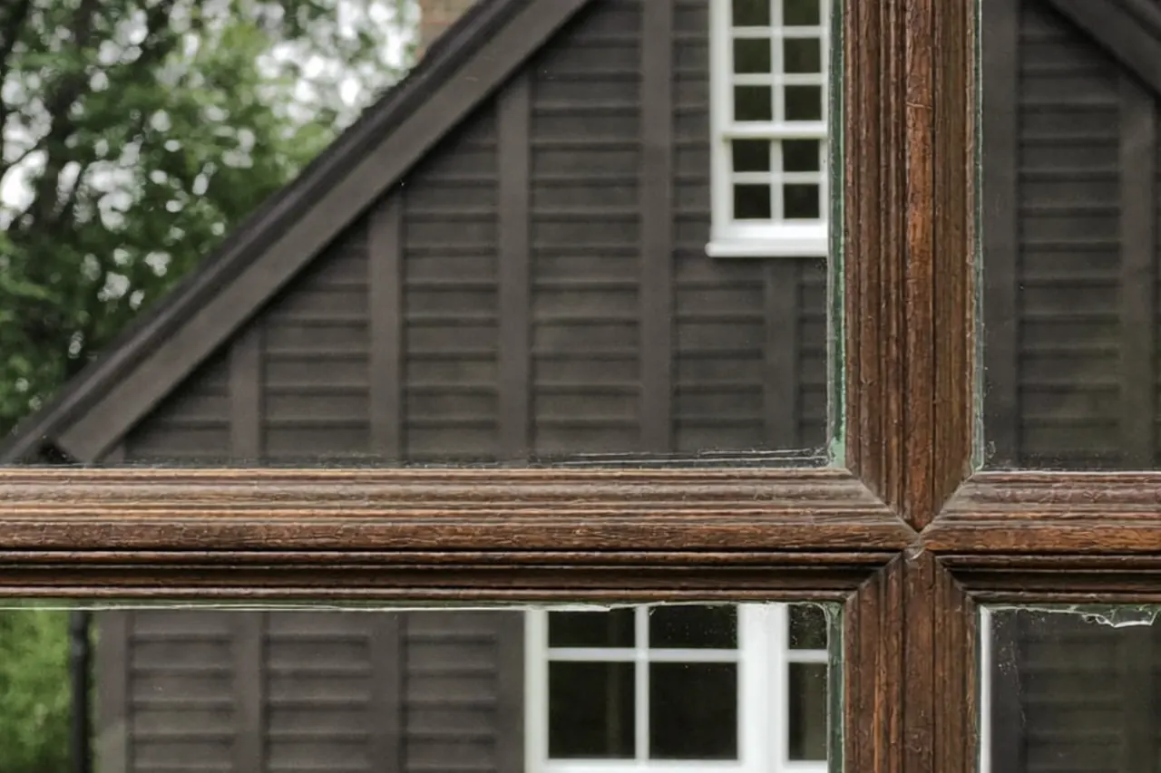 Close-up detail of a slim sash window frame and glazing bar on a terraced home